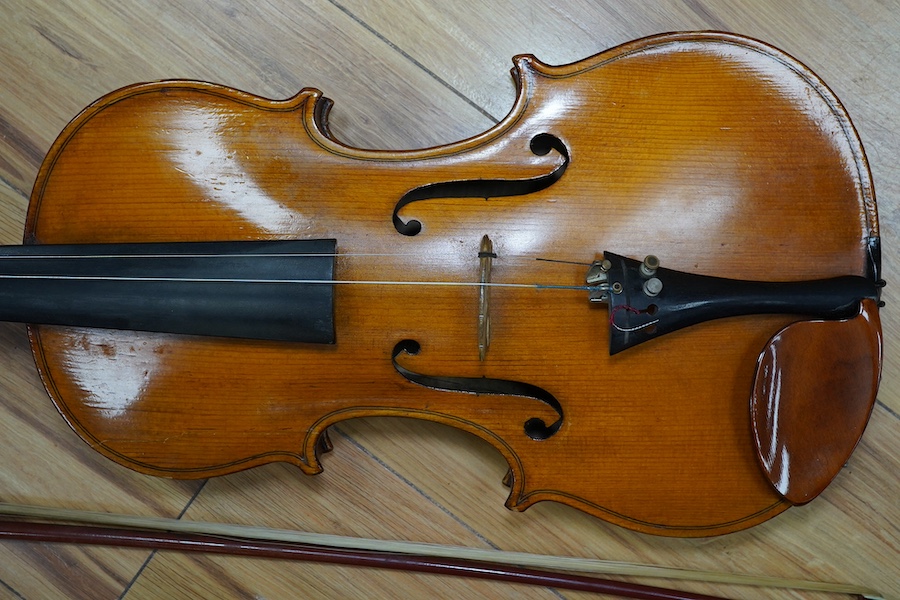 A cased early 20th century European violin, with label reading ‘Antonius Stradivarius Cremonenfis’, body length 36cm, with P&H London bow. Condition - good